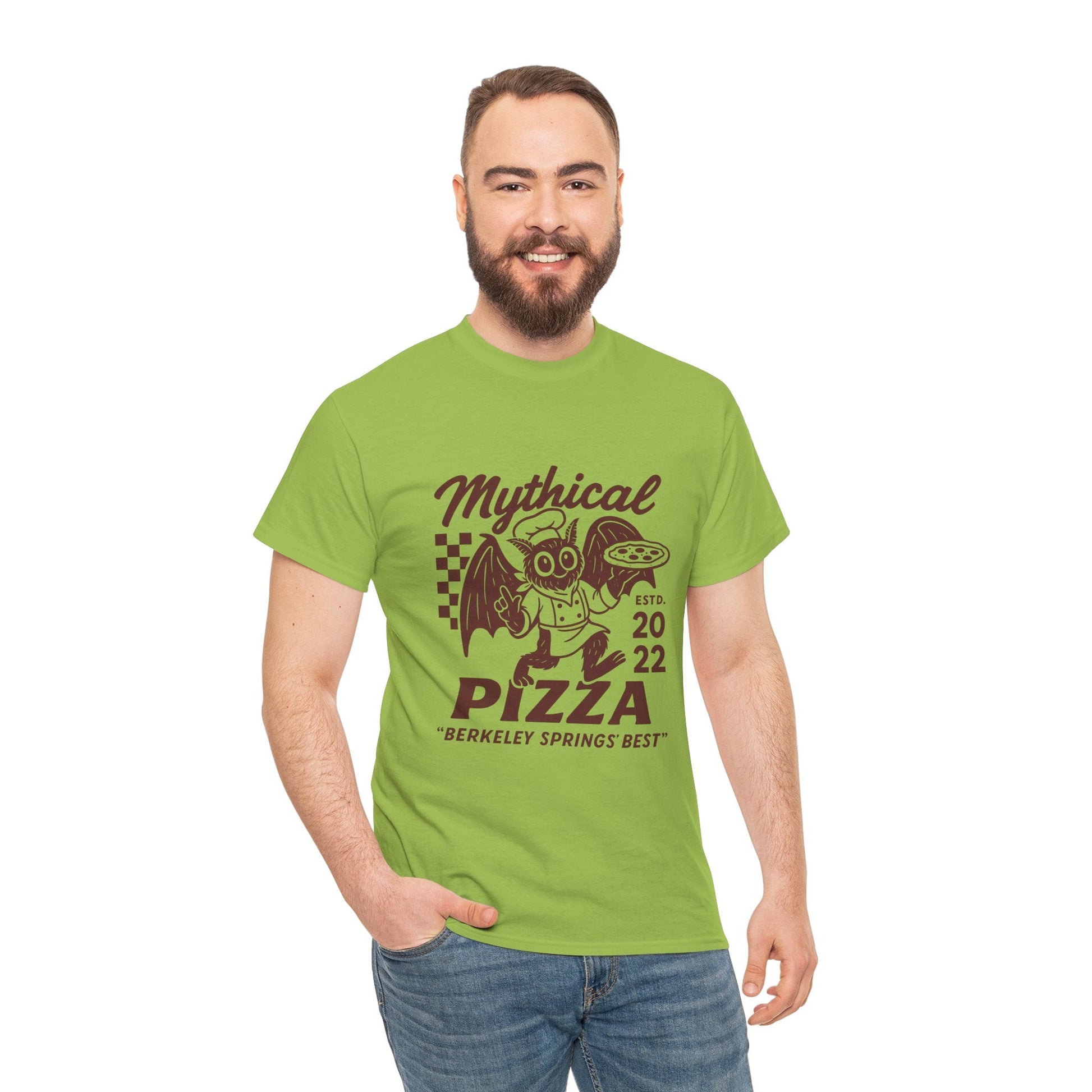 Man wearing a green "Mythical Pizza" t-shirt with jeans, smiling.