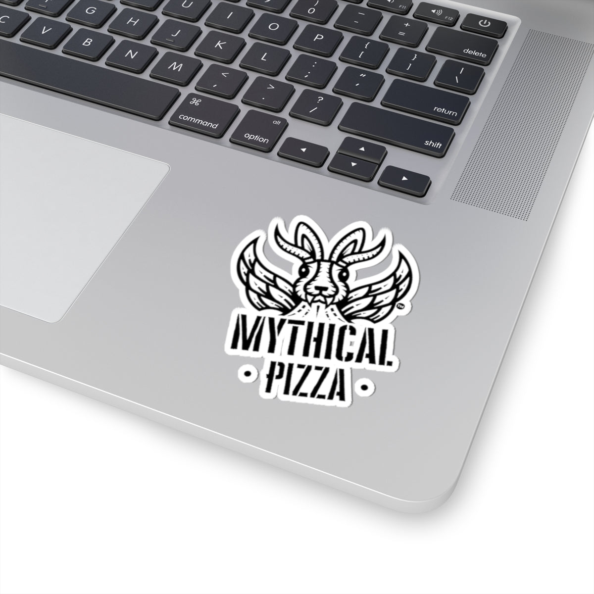 Sticker on a silver laptop displaying "Mythical Pizza" above and below a winged rabbit.